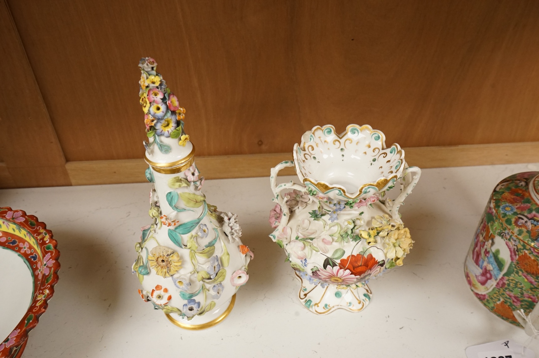 An English porcelain flower encrusted scent bottle and stoppers and a similar vase, c.1835, tallest 28cm